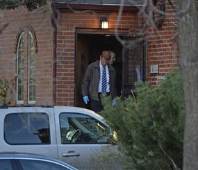 In this April 15, 2014 photo, authorities investigate a homicide in Denver. Richard Kirk is being held for investigation of first-degree murder in the death of his wife in their Denver home.