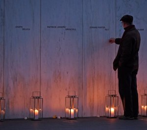 A man pays his respects at the Wall of Names at the United Flight 93 National Memorial in Shanksville, Pa., Saturday, Sept. 10, 2017.
