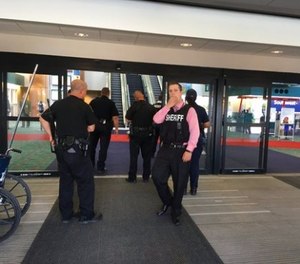 Police officers gather at a terminal at Bishop International Airport, Wednesday morning, June 21, 2017, in Flint, Mich. (Dominic Adams/The Flint Journal-MLive.com via AP)