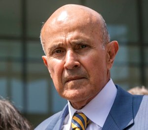 In this May 12, 2017, file photo, former Los Angeles County Sheriff Lee Baca leaves federal court in Los Angeles after he was sentenced to three years in prison for obstructing an FBI investigation into abuses at the jails he ran. (AP Photo/Damian Dovarganes, File)