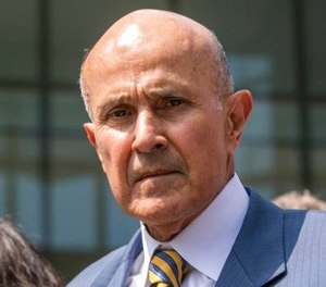 Former Los Angeles County Sheriff Lee Baca leaves federal court in Los Angeles after he was sentenced to three years in prison for obstructing an FBI investigation into abuses at the jails he ran. (AP Photo/Damian Dovarganes)