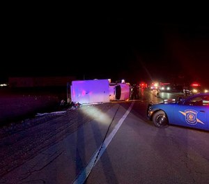 Four people were injured, including two ambulance crewmembers and their patient, in a rollover ambulance collision on Monday.
