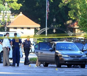 St. Louis police investigate the scene of a shooting where a gunman opened fire on a uniformed St. Louis police sergeant on Tuesday, July 14, 2015.
