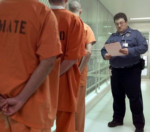 Oklahoma corrections officer Sgt. John Thomas checks the inmates he is moving to another area of the Lexington, Okla., assessment center Thursday, March 1, 2001.