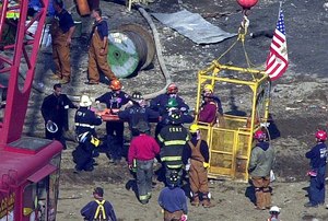 Firefighters remove a basket with victims' remains after it was pulled from the wreckage of the World Trade Center in New York on Oct. 2, 2001. Firefighter Robert Olsen claims he suffered asthma resulting from Lou Gehrig’s Disease as a result of 30 days he breathed in the toxic air while aiding rescue and recovery efforts at the World Trade Center site in 2001.