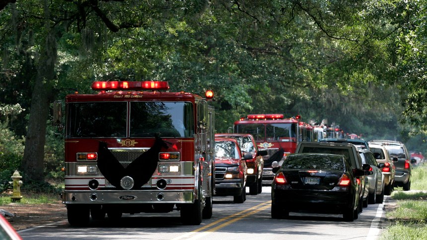 Charleston Fire Department trucks make their way to Pinecrest Baptist Church, in Charleston, S.C., following the public memorial service at the North Charleston Coliseum, on Friday, June 22, 2007, for a private ceremony to pay their final respects to Capt. Billy Hutchinson.