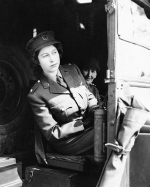 Princess Elizabeth seated at the driving wheel of an ambulance in April 1945.
