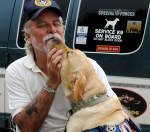 This Aug. 28, 2009 photo shows Vietnam veteran Bill Callahan talking to his service dog Tailor.