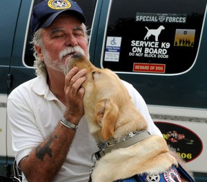 This Aug. 28, 2009 photo shows Vietnam veteran Bill Callahan talking to his service dog Tailor.