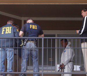 Federal agents get ready to search the apartment of a terrorism suspect in Aurora, Colorado.