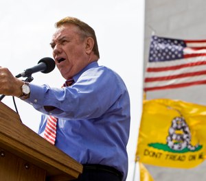 In this April 15, 2010 file photo, former Wisconsin Gov. Tommy Thompson addresses a tea party rally in Madison, Wis.