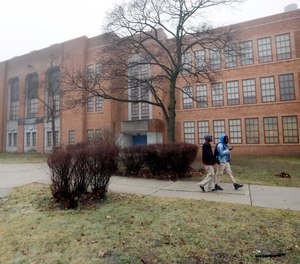 Students walk outside Pershing High School, Friday, Jan. 20, 2017, in Detroit.