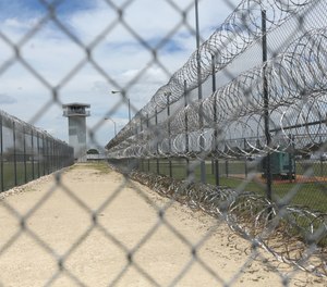 This Wednesday, June 21, 2017 photo shows barbed wire surrounding the prison in Gatesville, Texas.
