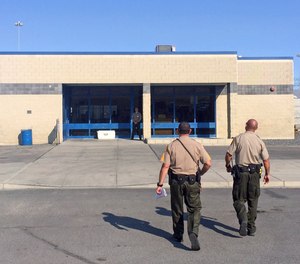 Officers walk toward the entrance to Nevada's Lovelock Correctional Center in Lovelock, Nevada.