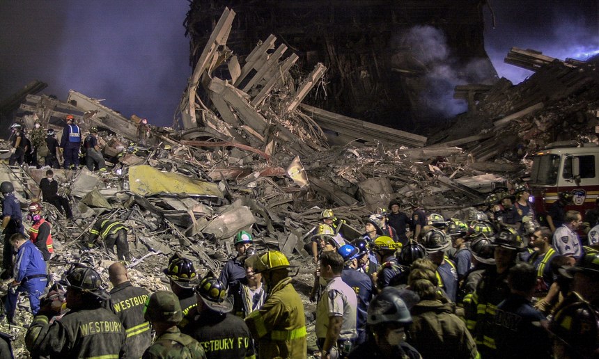 Workers stand at Ground Zero in New York, Sept. 12, 2001.