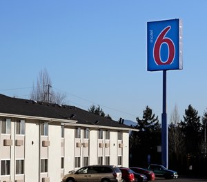 Police say a naked woman who may have ingested an unknown substance kicked an EMT in the face at a Motel 6.