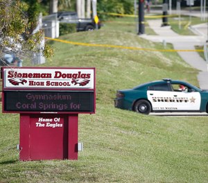 Law enforcement officers block off the entrance to Marjory Stoneman Douglas High School, Thursday, Feb. 15, 2018 in Parkland, Fla.