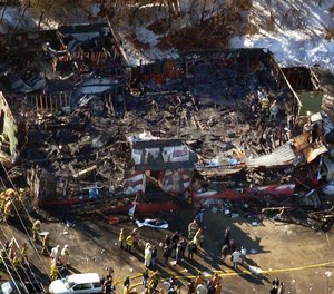 In this Feb. 20, 2003, aerial file photo, firefighters work amid the charred ruins of The Station nightclub, where 100 people died in a late night fire in West Warwick, R.I., started when pyrotechnics for the rock band Great White set fire to flammable foam installed as soundproofing.