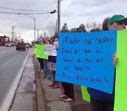 This Feb. 21, 2018 photo made available by Lex18 News, shows a group protesting school safety in Laurel County, Ky. In the wake of a mass shooting at a Florida high school, parents and educators are mobilizing to demand more school safety measures, including armed officers, security cameras, door locks, etc.
