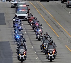 A long line of IMPD, Sheriff, and State Police officers escort the body of Boone Co. sheriff's deputy Jacob "Jake" Pickett, Monday, Mar. 5, 2018. (Kelly Wilkinson/The Indianapolis Star via AP)