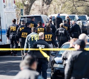 Authorities work on the scene of an explosion in Austin on Monday, March 12, 2018. (Ricardo B. Brazziell/Austin American-Statesman via AP)