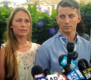 In this July 13, 2015 file photo, Denise Huskins, left, and her boyfriend Aaron Quinn listen as their attorneys speak at a news conference in Vallejo, Calif.