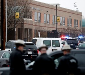 Deputies and federal agents converge on Great Mills High School, the scene of a shooting, Tuesday morning, March 20, 2018 in Great Mills, Md. The shooting left three people injured including the shooter. Authorities said the situation was 