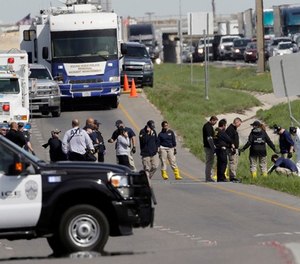 Officials continue to investigate the scene where a suspect in a series of bombing attacks in Austin blew himself up as authorities closed in, Wednesday, March 21, 2018, in Round Rock, Texas.