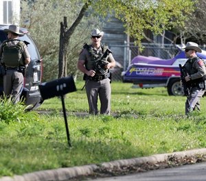 Law enforcement officers secure the neighborhood at the scene of Walnut and 2nd Street in Pflugerville, Texas, on Wednesday, March 21, 2018 where Austin, Texas bombing suspect Mark Anthony Conditt lived.