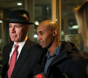 Former Minneapolis Police Officer Mohamed Noor leaves the Hennepin County Public Safety Facility with his attorney, Thomas Plunkett, left, after posting bail Wednesday night, March 21, 2018, in Minneapolis. (Jeff Wheeler/Star Tribune via AP)