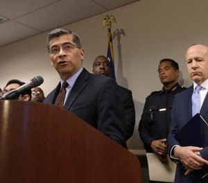California Attorney General Xavier Becerra, left, discusses his office's involvement of an investigation into the killing of Stephon Clark by two Sacramento Police officers, Tuesday, March 27, 2018, in Sacramento, Calif. (AP Photo/Rich Pedroncelli)