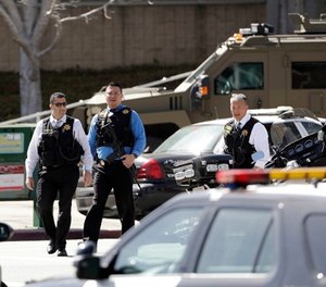 Armed law enforcement personnel exit YouTube headquarters, Tuesday, April 3, 2018, in San Bruno, Calif. A woman opened fire at YouTube headquarters Tuesday, setting off a panic among employees and wounding several people before fatally shooting herself, police and witnesses said.