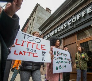 Protesters gather outside of a Starbucks in Philadelphia, Sunday, April 15, 2018, where two black men were arrested Thursday after employees called police to say the men were trespassing.