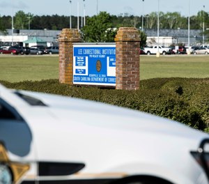 A police vehicle sits outside the Lee Correctional Institution on Monday, April 16, 2018, in Bishopville, S.C. Multiple inmates were killed and others seriously injured amid fighting between prisoners inside the maximum security prison in South Carolina.