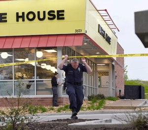 Law enforcement officials work the scene of a fatal shooting at a Waffle House in the Antioch neighborhood of Nashville, Sunday, April 22, 2018. (George Walker IV/The Tennessean via AP)