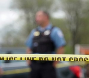In this May 4, 2018 file photo Police from various agencies investigate the scene where a Bureau of Alcohol, Tobacco, Firearms and Explosives agent was shot, May 4, 2018, in Chicago.