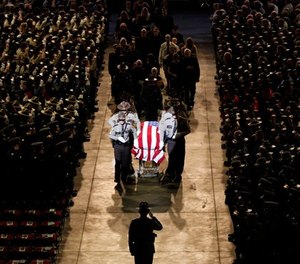Pallbearers walk alongside the casket of Cpl. Eugene Cole at the conclusion of the funeral service at the Cross Insurance Center, Monday, May 7, 2018, in Bangor, Maine. Cole, a sheriff's deputy, was the first officer to be killed in the line of duty in Maine in early 30 years when he was killed early on April 25 in Norridgewock.