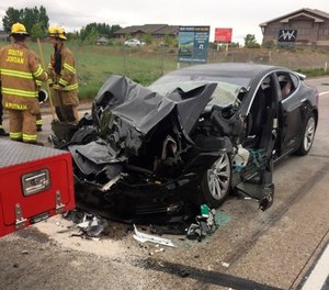 n this Friday, May 11, 2018, photo released by the South Jordan Police Department shows a traffic collision involving a Tesla Model S sedan with a Fire Department mechanic truck stopped at a red light in South Jordan, Utah. (South Jordan Police Department via AP)