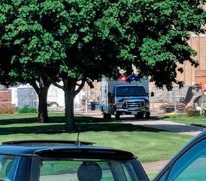 An emergency vehicle appears outside Dixon High School Wednesday, May 16, 2018 in Dixon, Ill. Officials say a police officer has shot and wounded a gunman at a northern Illinois high school.