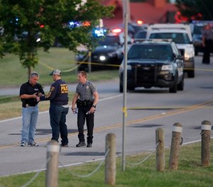 Authorities work the scene of a shooting on the east side of Lake Hefner in Oklahoma City, Thursday, May 24, 2018. (Sarah Phipps/The Oklahoman via AP)