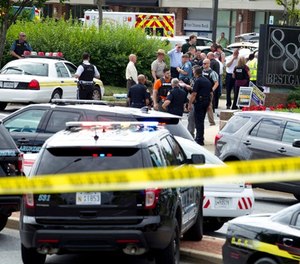 Authorities stage at the office building entrance after multiple people were shot at The Capital Gazette newspaper in Annapolis, Md., Thursday, June 28, 2018.
