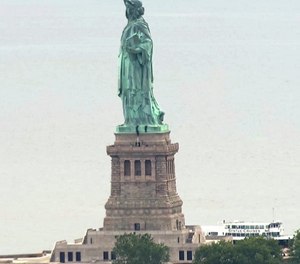 In this image taken from video, people climb on the pedestal of the Statue of Liberty in New York Harbor Wednesday, July 4, 2018. (AP Photo)