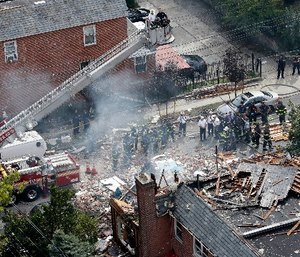 In this Sept. 27, 2016 file photo, emergency service personnel work at the scene of a house explosion in the Bronx borough of New York where firefighter Michael Fahy, a 17-year fire department veteran was killed after responding to a report of a gas leak at the home.