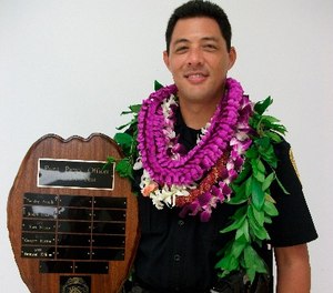 This undated photo provided by the Hawaii County Police Department shows Officer Bronson Kaliloa. A manhunt is underway for a suspect wanted for fatally shooting Kaliloa during a traffic stop on Hawaii's Big Island, officials said Wednesday, July 18, 2018. (Hawaii County Police Department via AP)