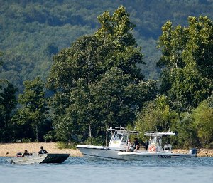 Rescue crews work at the scene of a deadly boat accident at Table Rock Lake in Branson, Mo., Thursday, July 19, 2018. A sheriff in Missouri said a tourist boat has apparently capsized on the lake, leaving several people dead and several others hospitalized.