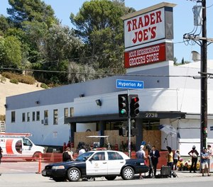 Police officers guard the entrance to the Trader Joe's Los Feliz store, as it remains closed for business, Sunday, July 22, 2018, in Los Angeles. (AP Photo/Damian Dovarganes)
