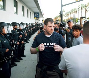 In this June 2, 2016 file photo, a man leaving a campaign rally for Republican presidential candidate Donald Trump squares off against protesters following him in San Jose, Calif. A federal appeals court is allowing supporters of then-presidential candidate Donald Trump to sue, alleging they were beaten after San Jose police steered them into a crowd of anti-Trump protesters. (AP Photo/Noah Berger, File)