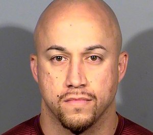 This undated file photo released by the Las Vegas Metropolitan Police Department shows Kenneth Lopera. Prosecutors in Las Vegas have dropped charges, including involuntary manslaughter, against Lopera, the former Las Vegas police officer accused of using an unapproved chokehold in the death of an unarmed man last year.