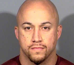 This undated file photo released by the Las Vegas Metropolitan Police Department shows Kenneth Lopera. Prosecutors in Las Vegas have dropped charges, including involuntary manslaughter, against Lopera, the former Las Vegas police officer accused of using an unapproved chokehold in the death of an unarmed man last year.