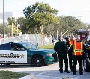 Broward County Sheriff's deputies stand outside Marjory Stoneman Douglas High School, Wednesday, Aug. 15, 2018, in Parkland, Fla. Students at the school returned Wednesday, to a more secure campus as they began their first new school year since a gunman killed 17 people in the freshman building. (AP Photo/Wilfredo Lee)